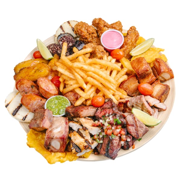 A large platter of Banana King's fast-food, including fries, various meats, plantains, and sauces.