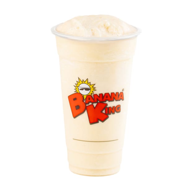 A Banana King banana milkshake in a clear plastic cup with the brand logo.