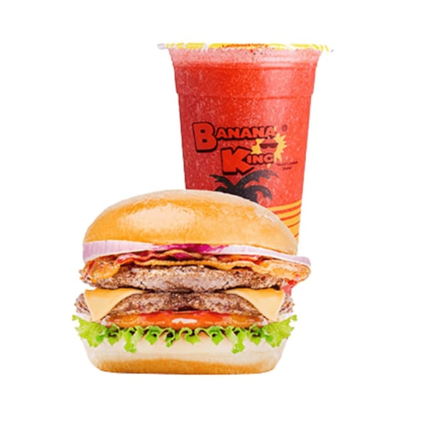 A Banana King double cheeseburger with bacon and a large red frozen drink.